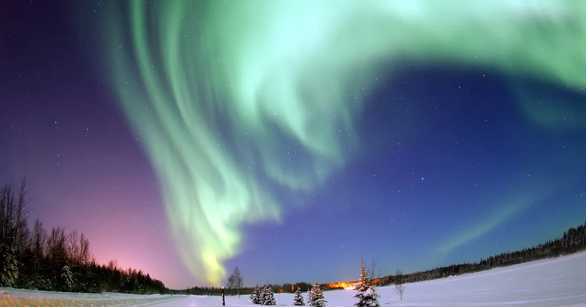 natural light display that occurs in the sky, primarily at high latitudes (near the Arctic and Antarctic on Earth) or even on other planets